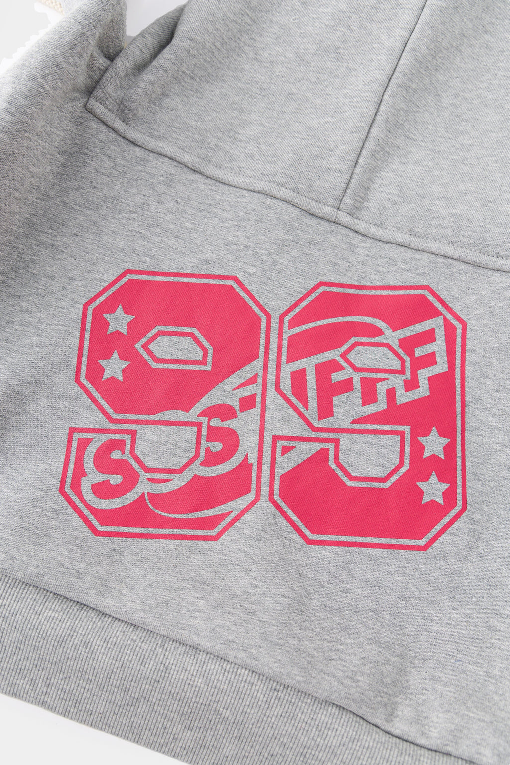Detail of the pink 99 print, with SSSTUFFF set into the digits.