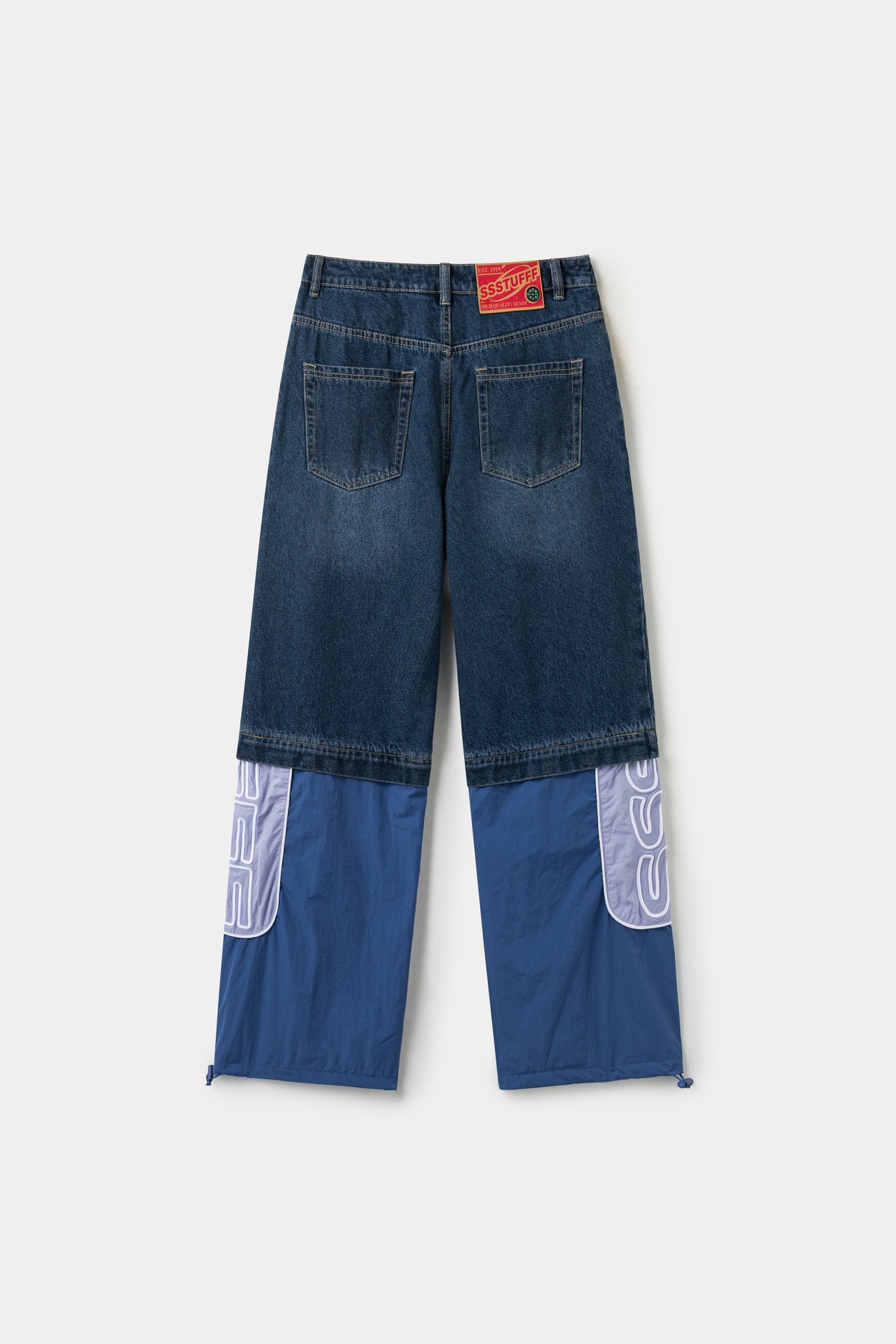 Back view of the full hybrid trackpants, denim shorts zipped to the blue nylon legs.
