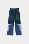 The hybrid trackpants unzipped at the knee, denim shorts above and the detachable nylon legs below.