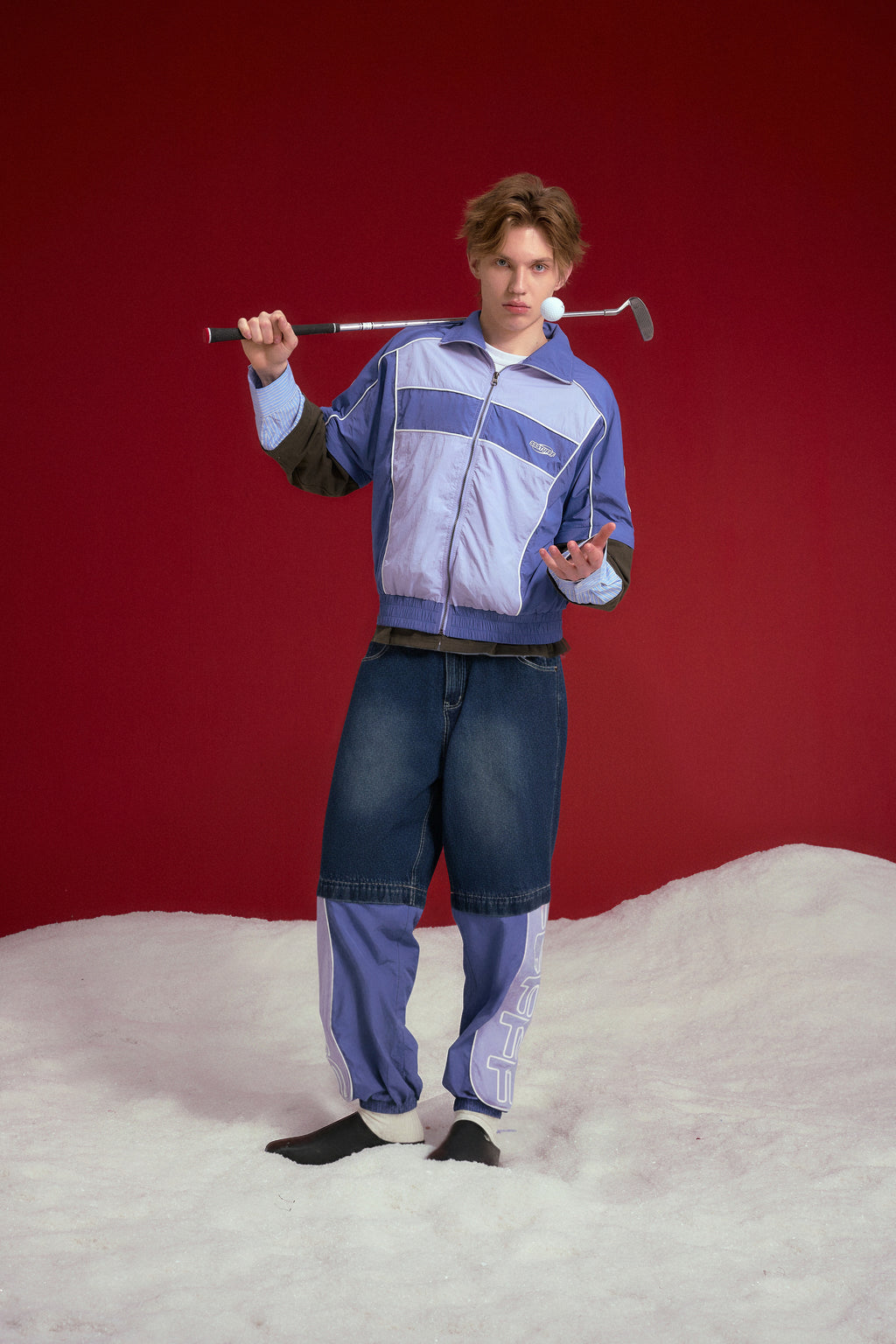 2 in 1 Hybrid Denim Trackpants worn on a male model with a golf club, full-length front view.