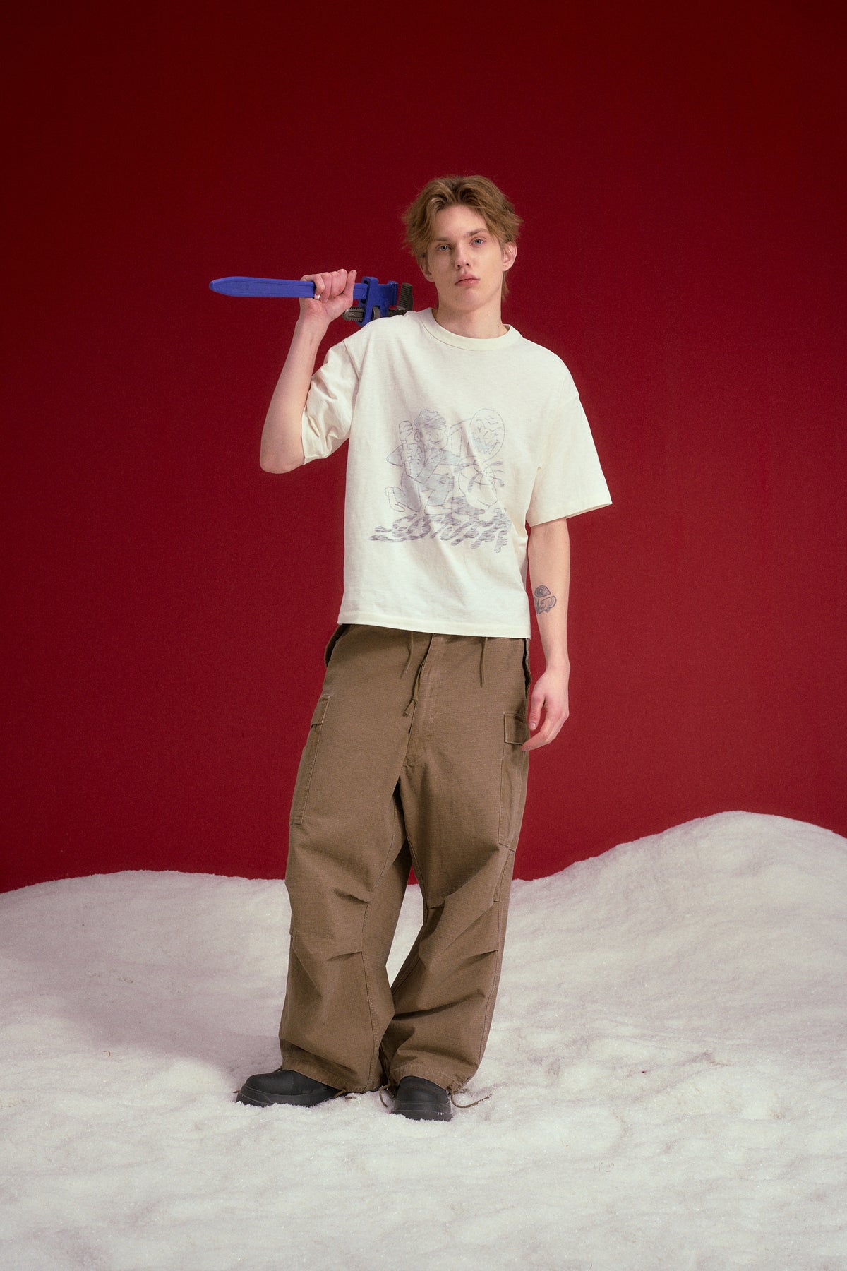 Inside Out Plumber Tee worn on a male model, full-length front view.