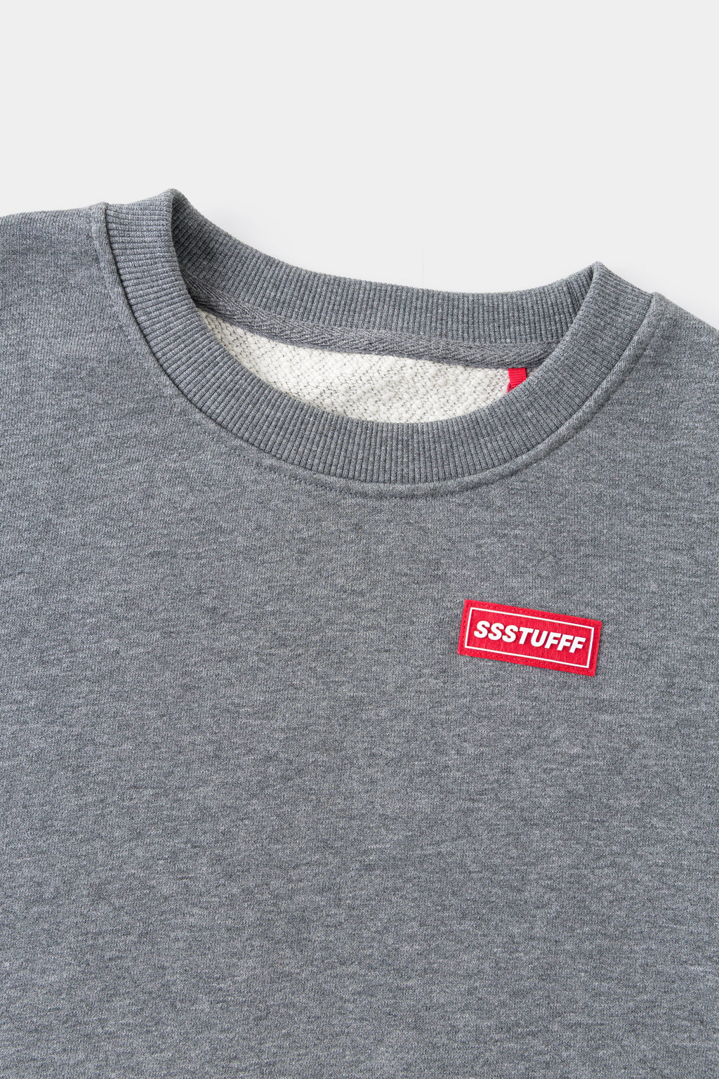 Close-up of the ribbed neckline and the red Ssstufff tab.