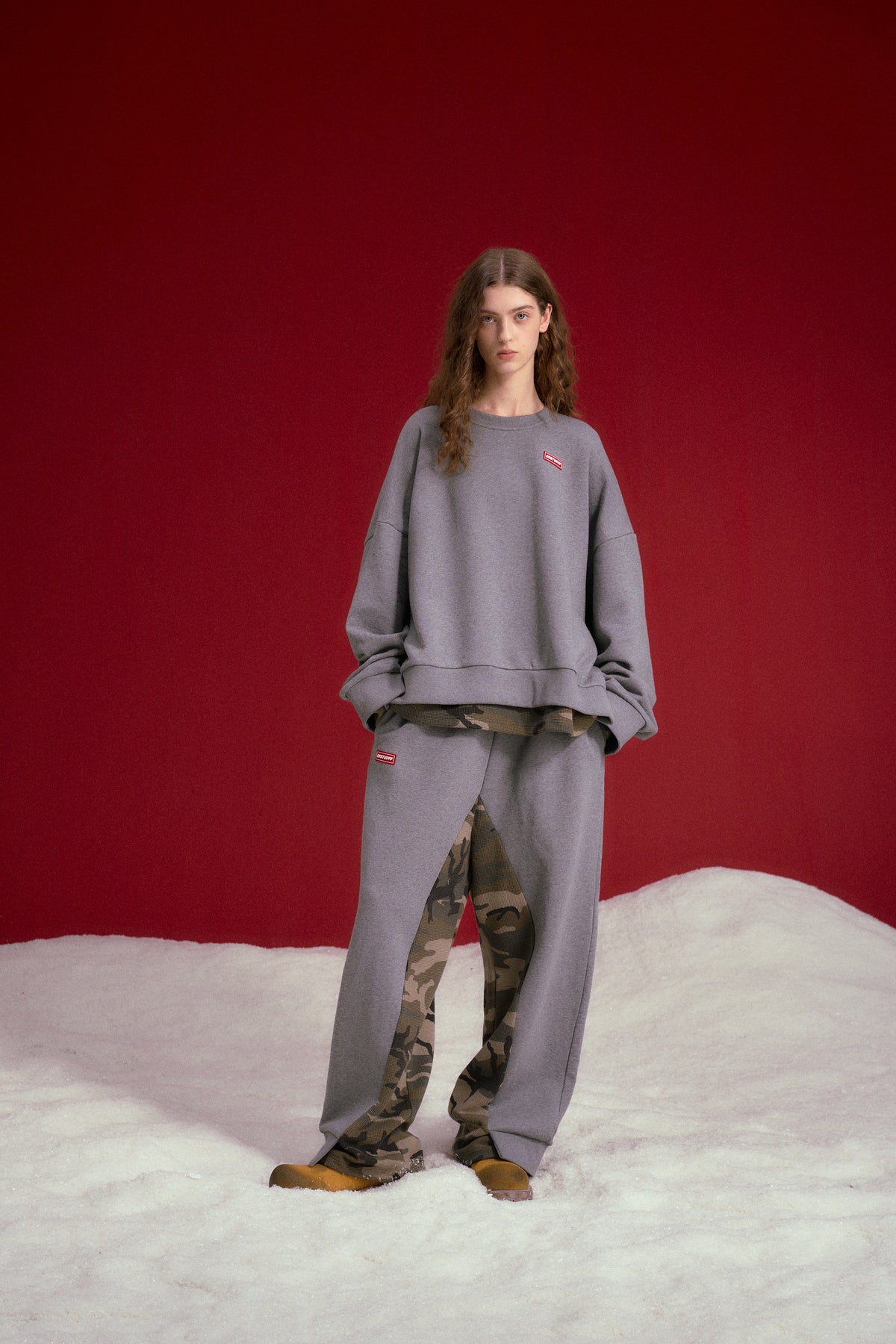 Layered Waffle Camo Pants in grey, worn over a waffle camo layer that shows at the hem. Worn on a model, full-length front view.