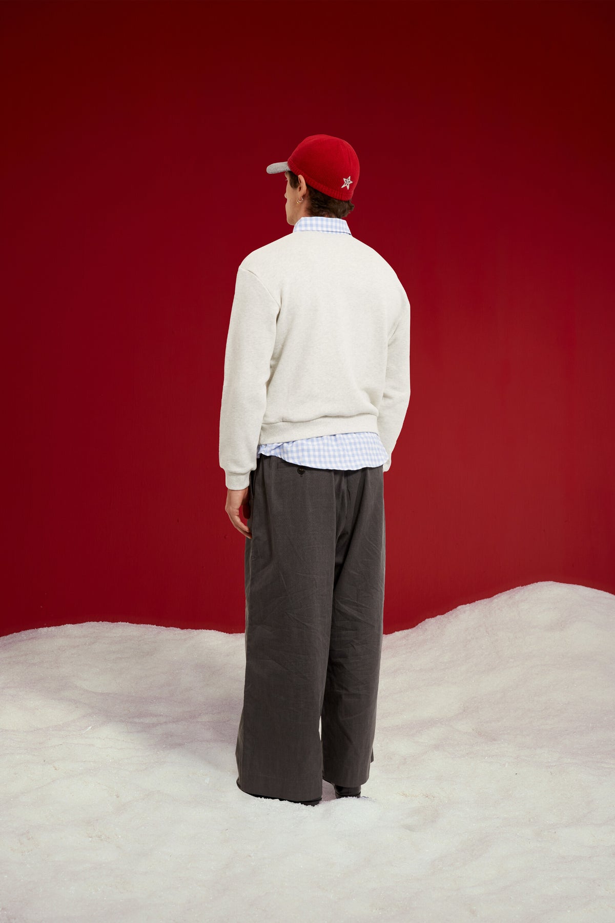 Layered Shirt Crewneck in grey marl, spliced with a blue gingham shirt collar and hem. Worn on a model, full-length back view.