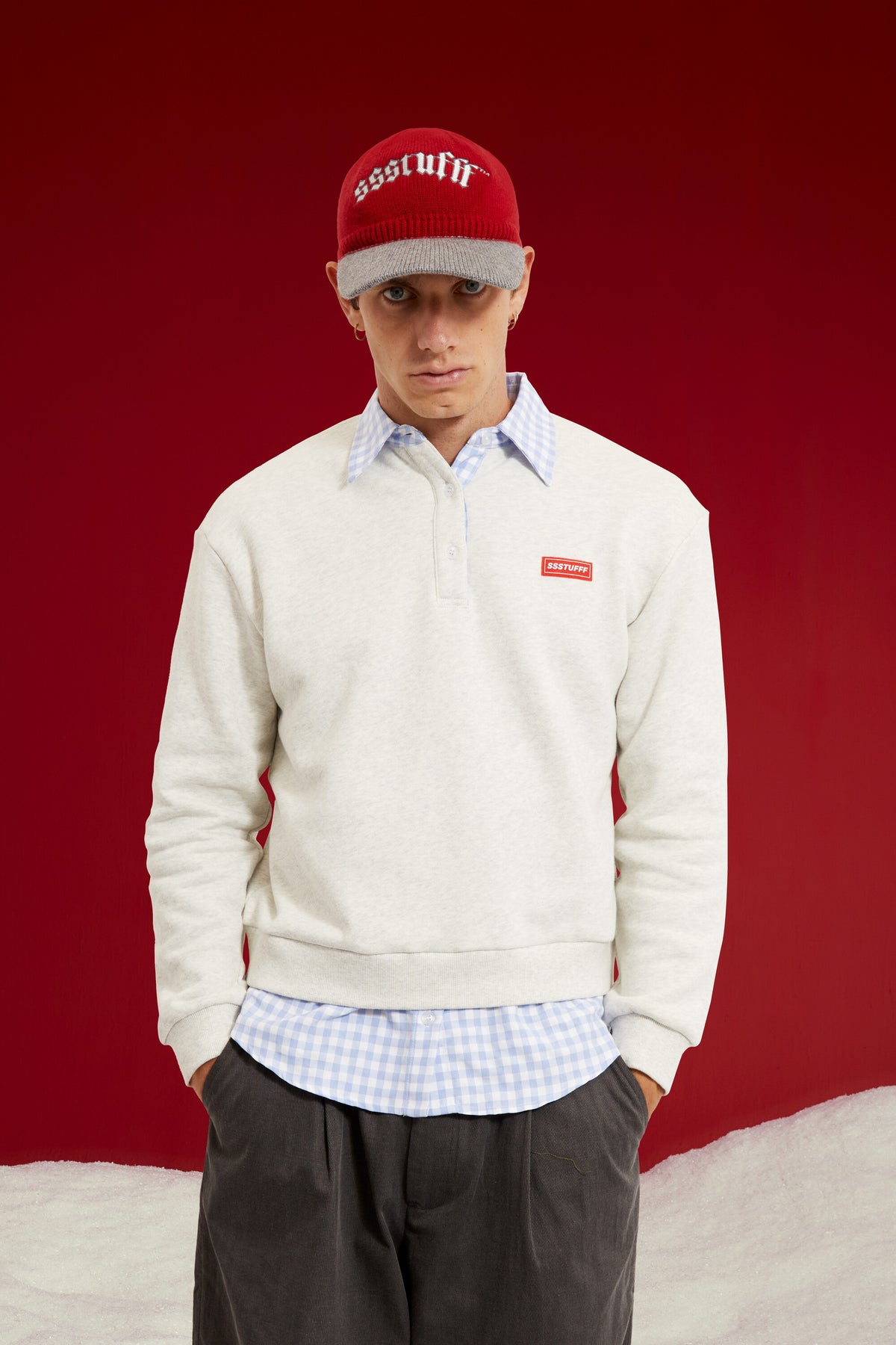 Layered Shirt Crewneck in grey marl, spliced with a blue gingham shirt collar and hem. Worn on a model, waist-up view.