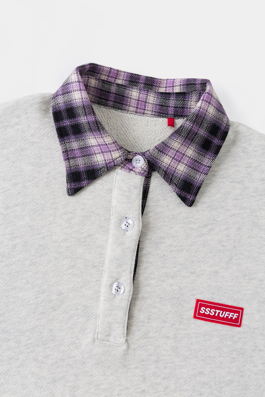 Close-up of the purple checked collar, placket buttons and red Ssstufff tab.