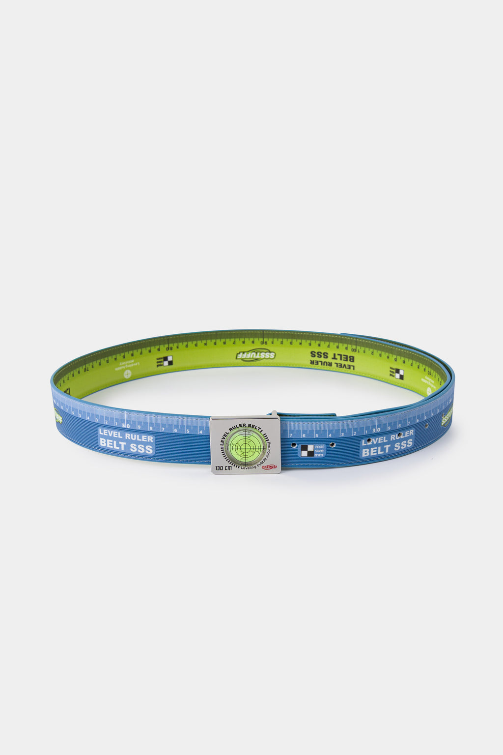 Swappable Level and Ruler Belt coiled into a ring, printed with a ruler scale and fitted with one of its two interchangeable spirit level buckles.