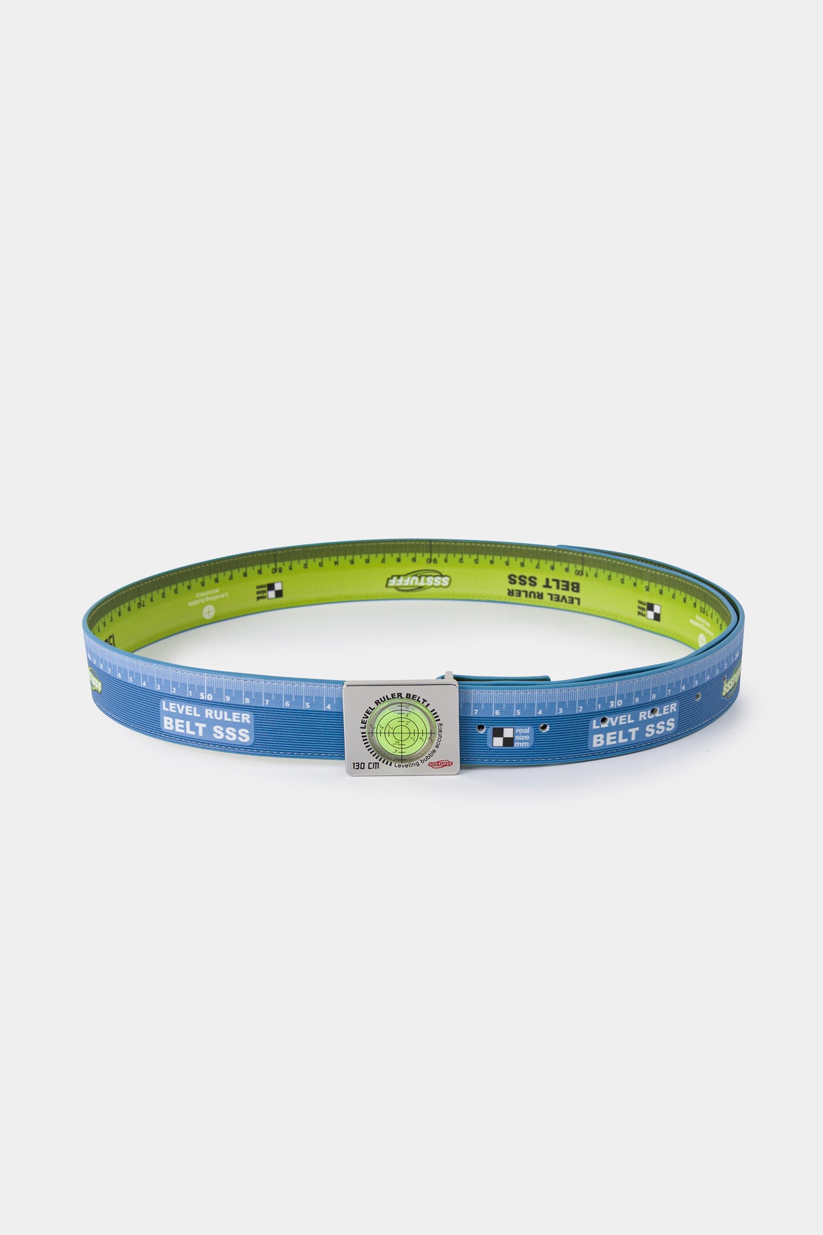 Swappable Level and Ruler Belt coiled into a ring, printed with a ruler scale and fitted with one of its two interchangeable spirit level buckles.