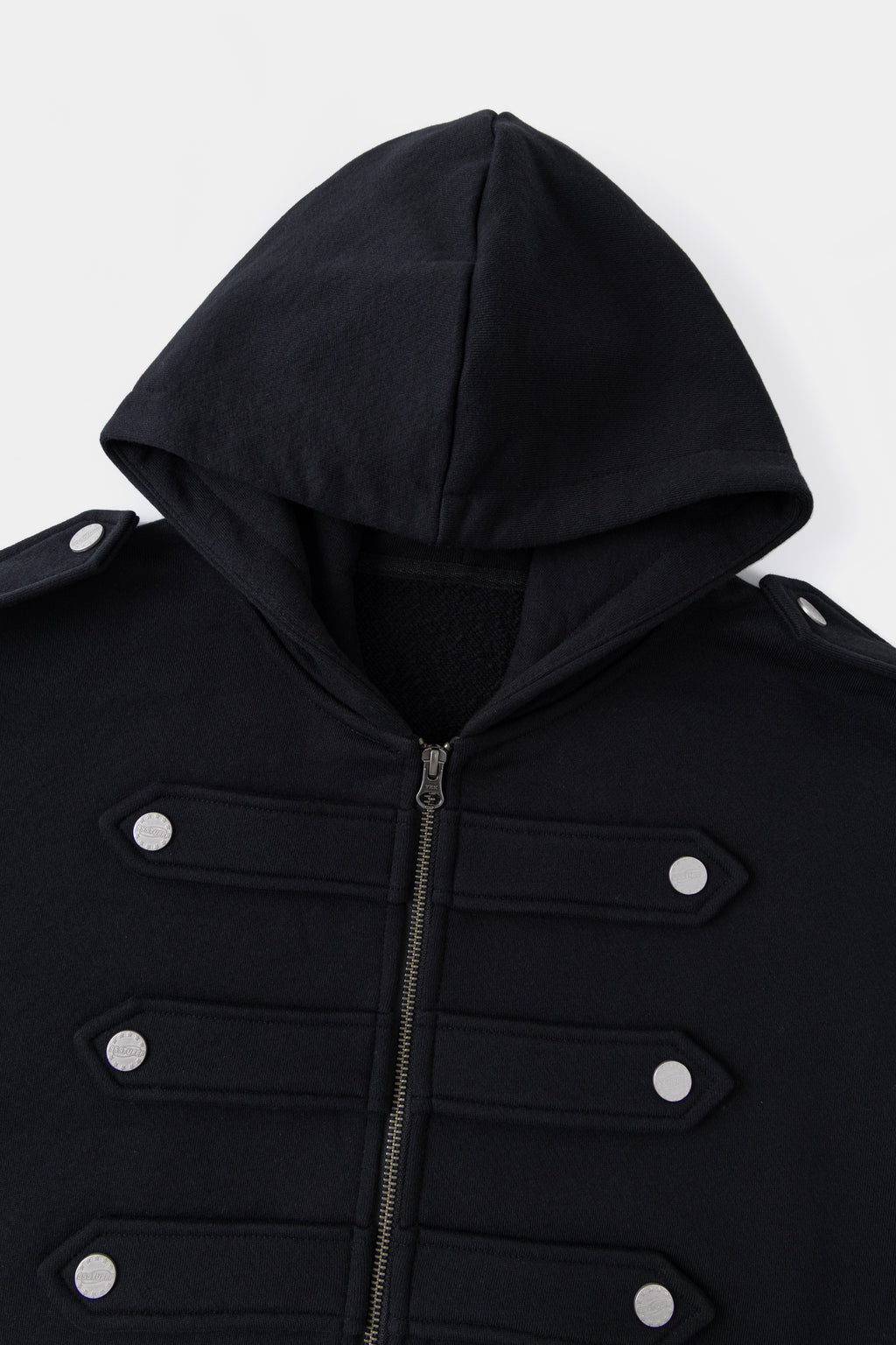 Close-up of the black hood and the six snap-fastened chest closures.