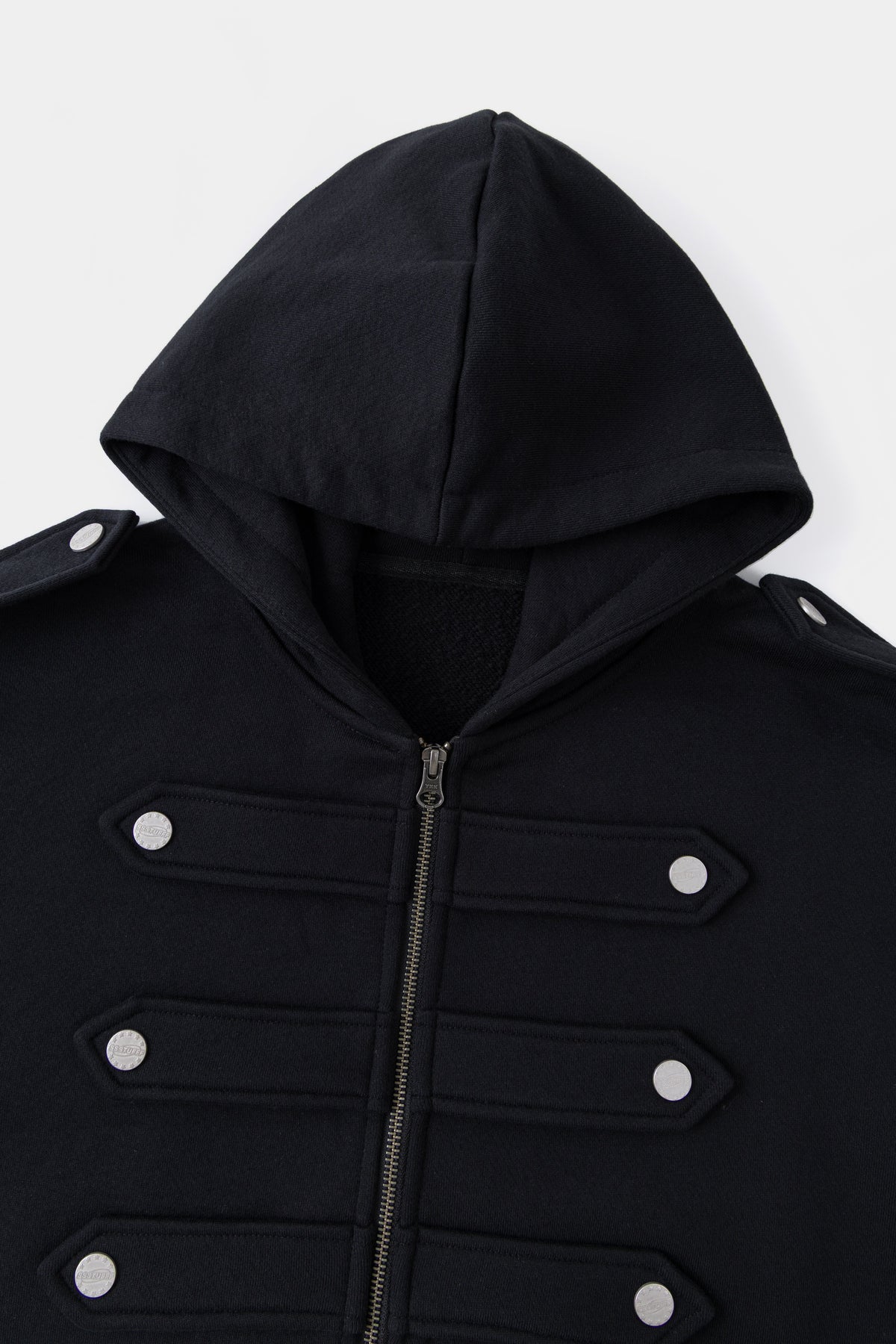 Close-up of the black hood and the six snap-fastened chest closures.