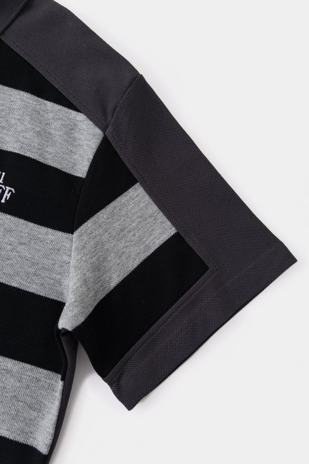 Close-up of the sleeve, where the striped layer ends and the solid charcoal sleeve continues.
