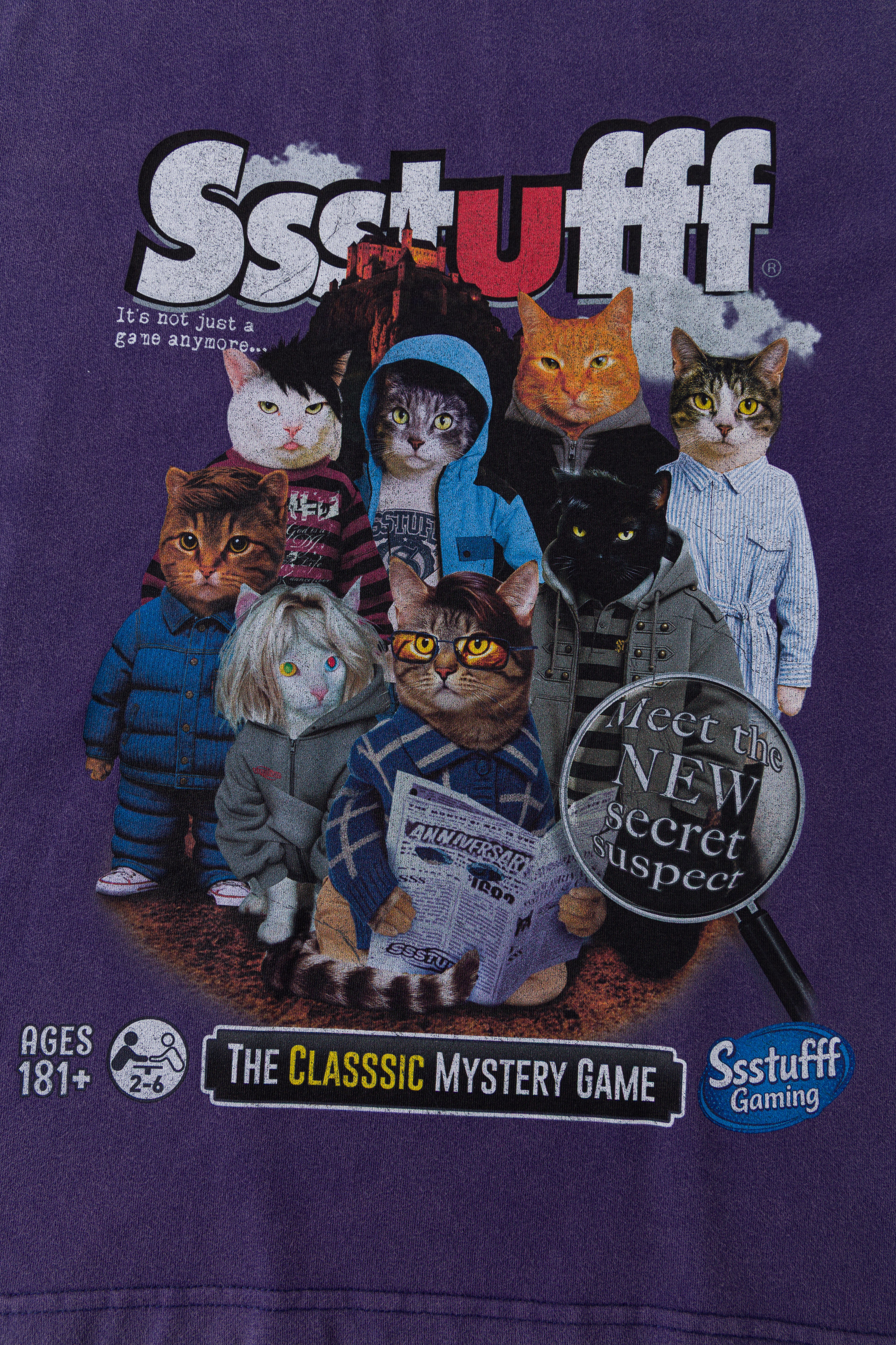 Close-up of the full chest print: the cats in costume, the Meet the New Secret Suspect magnifying glass and The Classic Mystery Game banner.