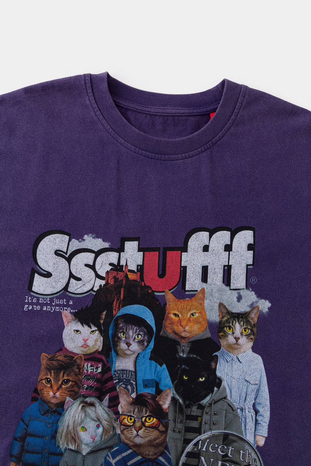 Close-up of the ribbed neckline and red Ssstufff tab above the cats print.