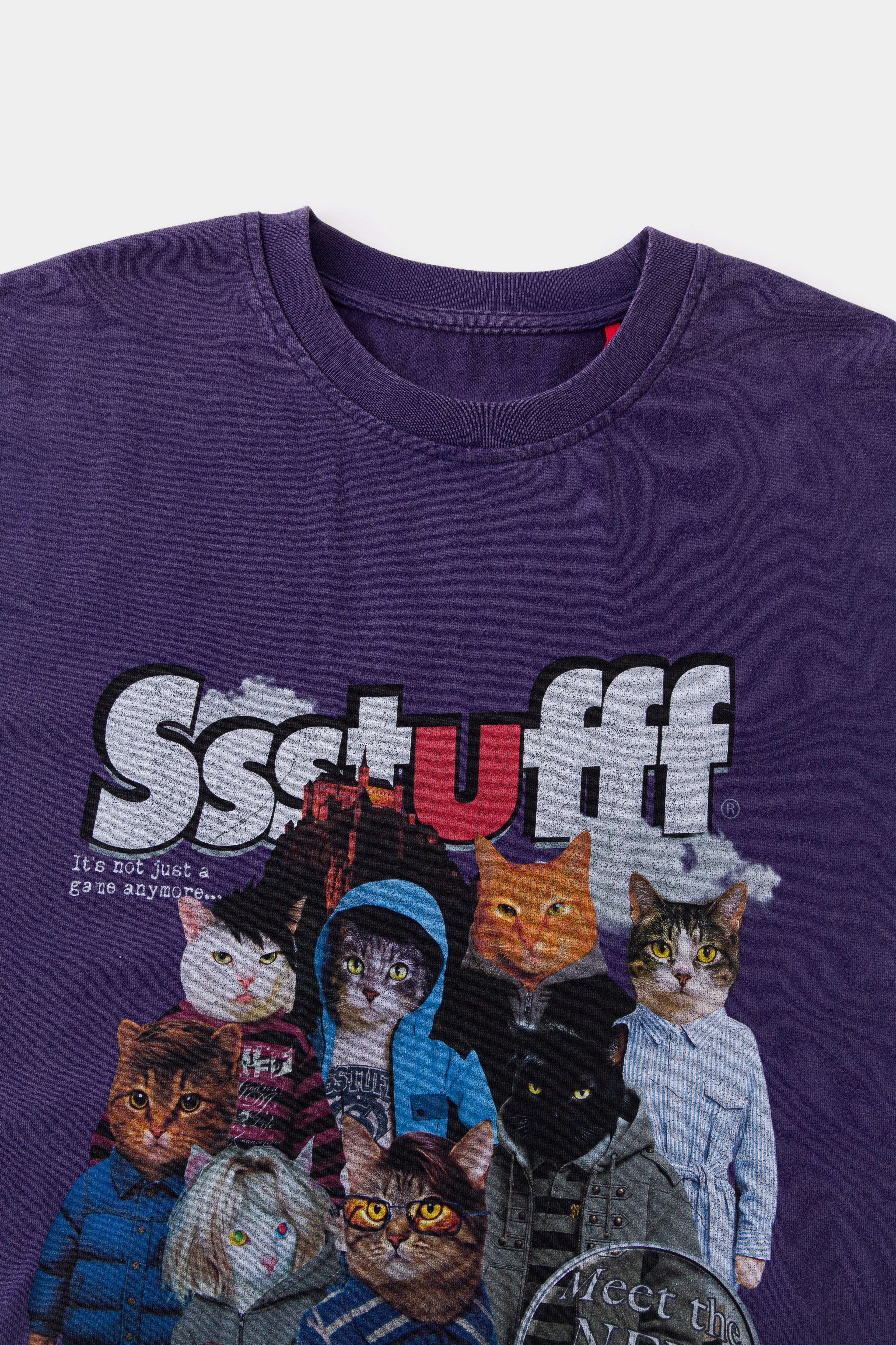 Close-up of the ribbed neckline and red Ssstufff tab above the cats print.