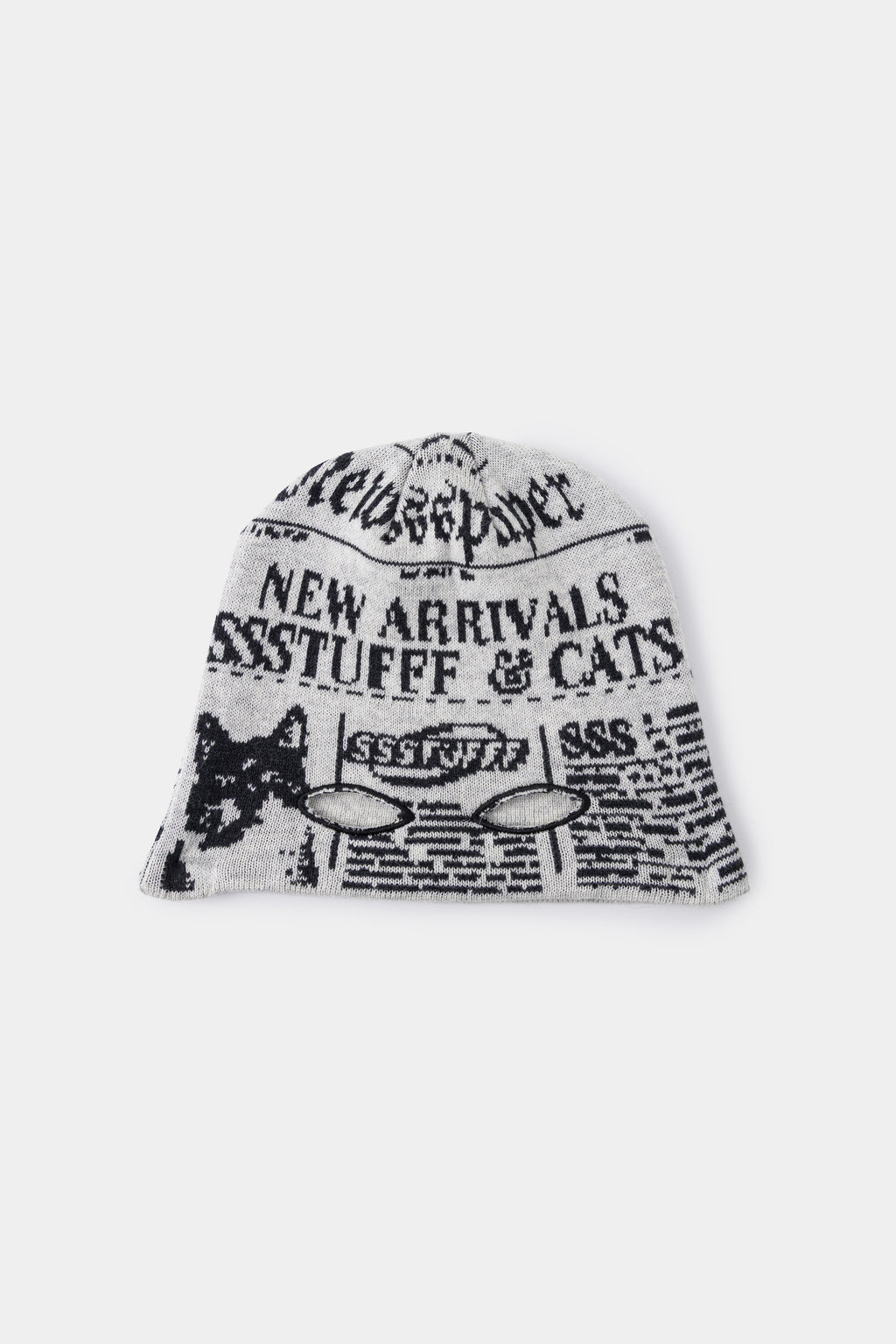 Newspaper Spy Beanie in newsprint jacquard, with two eye holes knitted into the front.