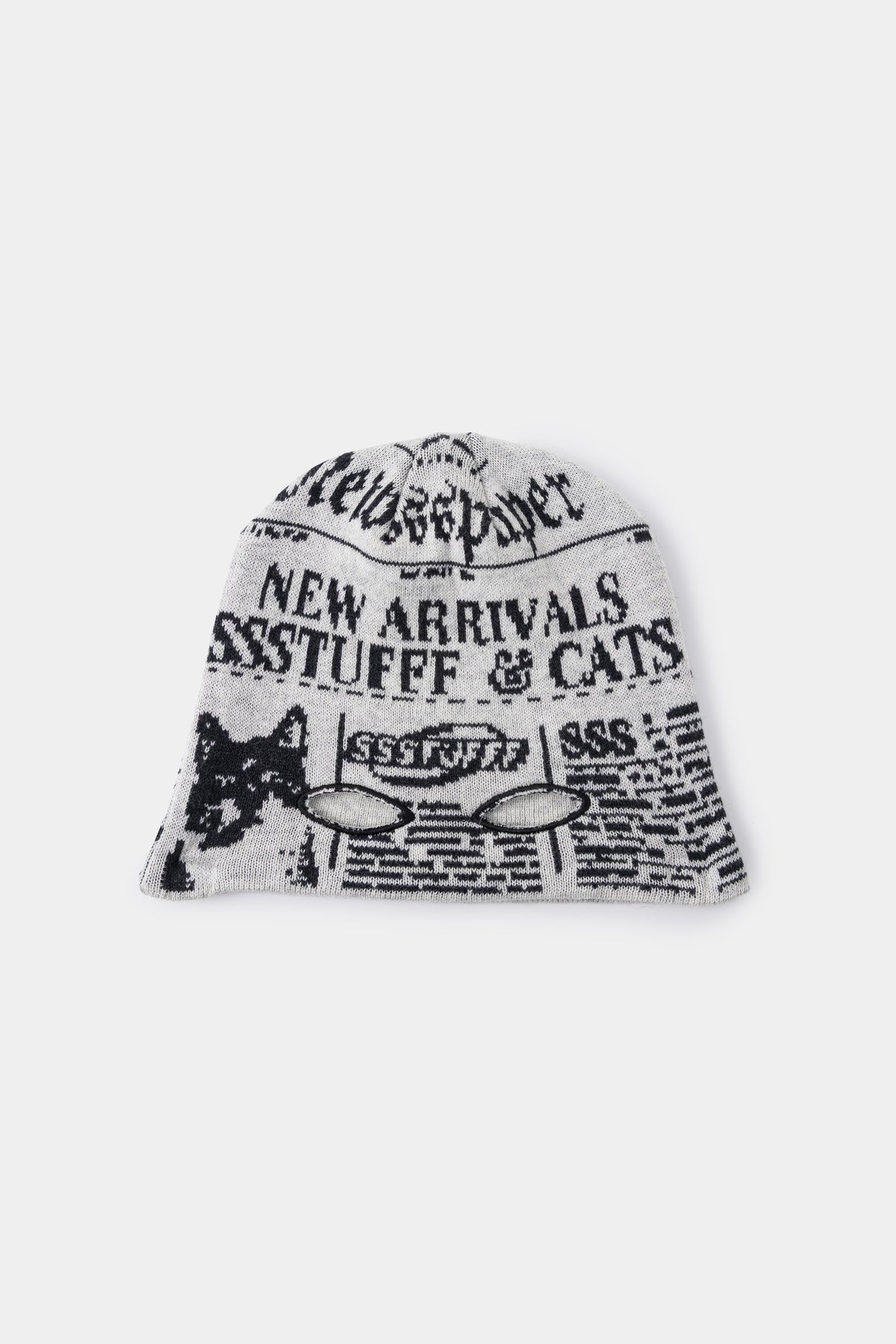 Newspaper Spy Beanie in newsprint jacquard, with two eye holes knitted into the front.