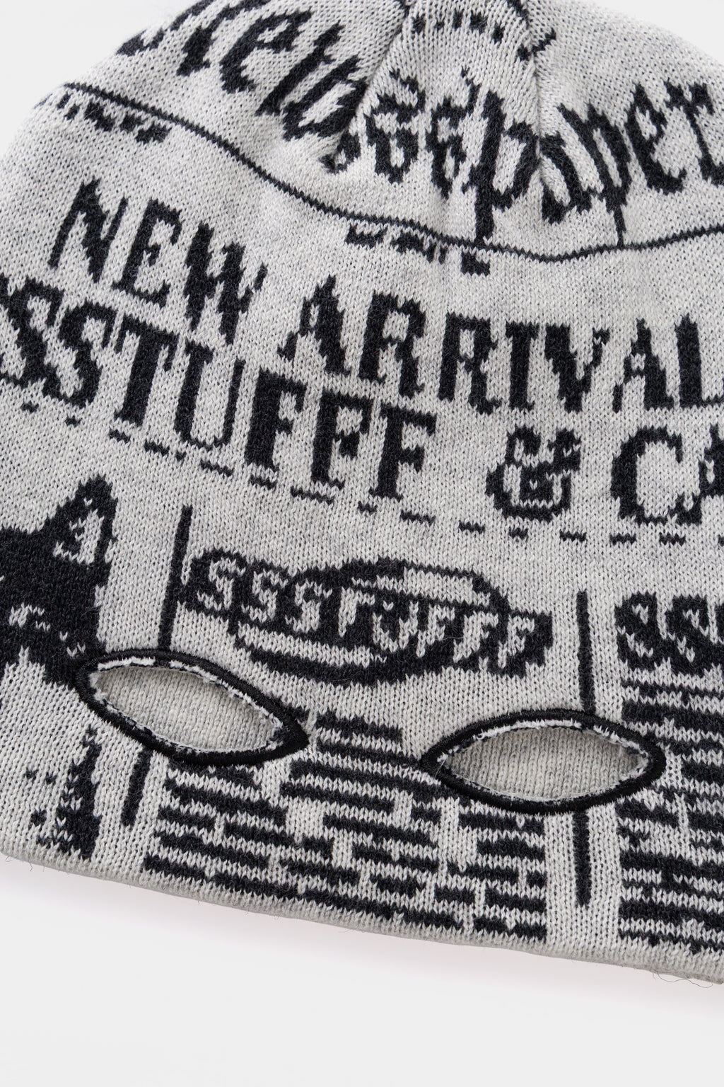 Detail of the two eye holes knitted into the paper, for reading and watching at once.