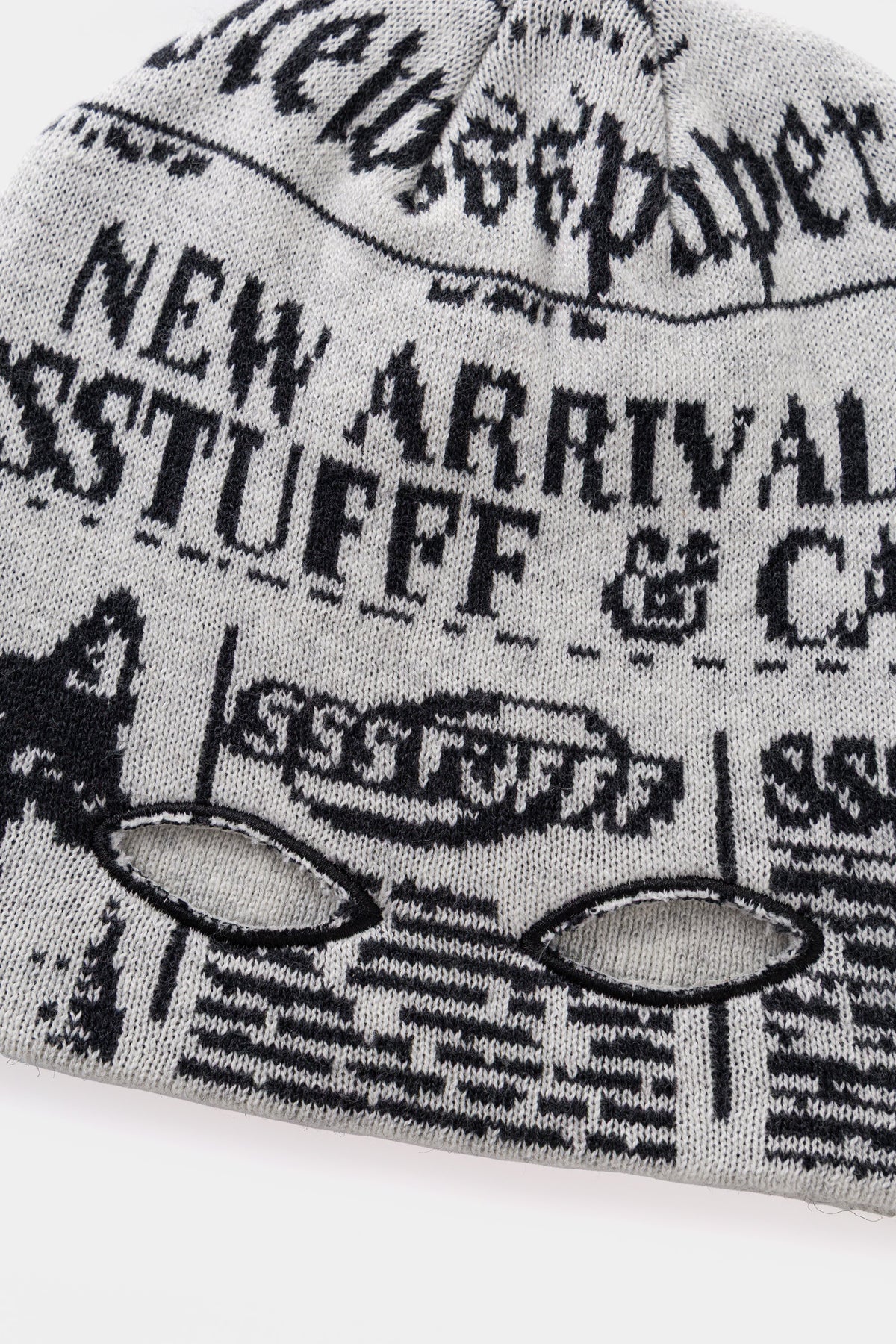 Detail of the two eye holes knitted into the paper, for reading and watching at once.