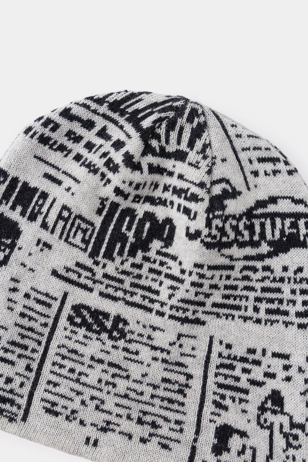 Close-up of the black and cream newsprint jacquard on the back of the beanie.