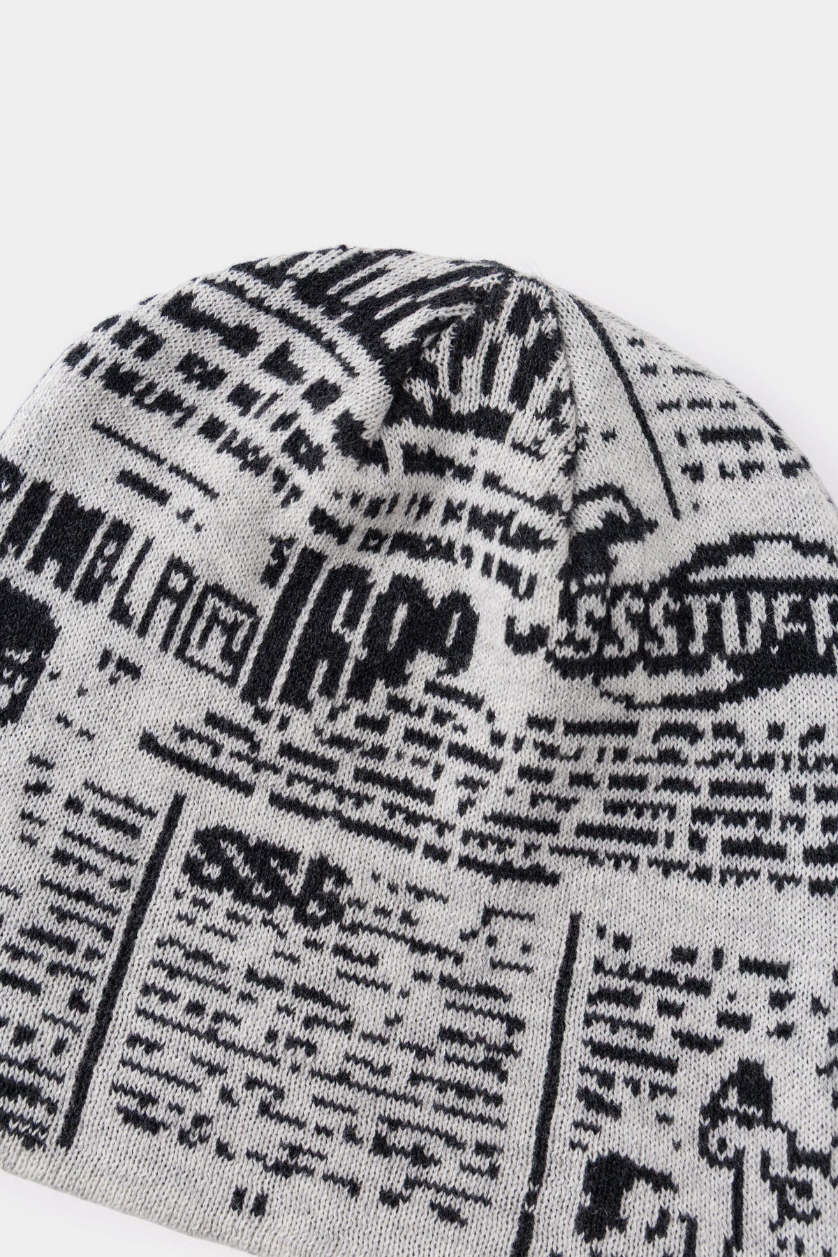 Close-up of the black and cream newsprint jacquard on the back of the beanie.
