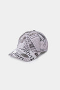 Newspaper Spy Cap in all-over newsprint print, a six-panel cap with a curved brim.