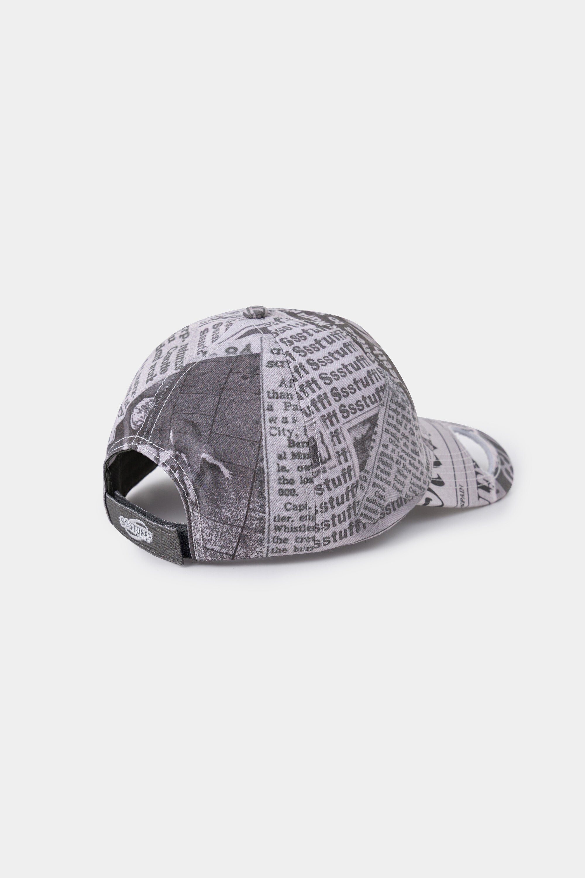 Back view of the newsprint cap, with the adjustable strap closed.