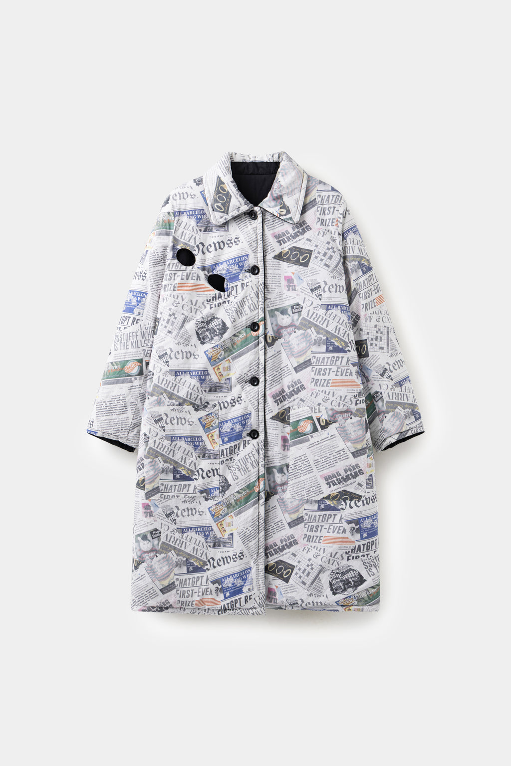 Newspaper Spy Coat, a long quilted reversible coat in all-over newspaper print with two eye holes cut through the chest.