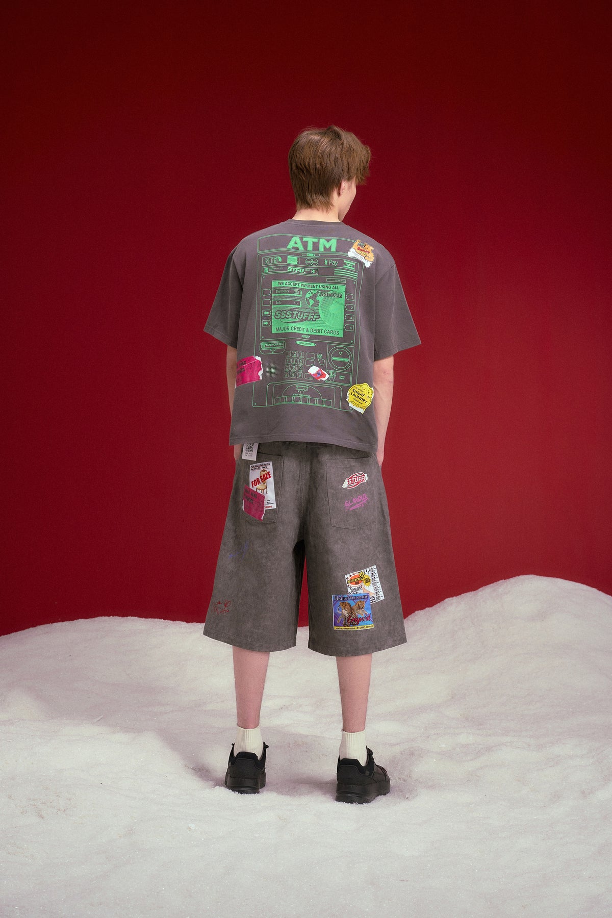 NFC ATM Tee in washed charcoal, with a contactless payment graphic at the chest. Worn on a model, full-length back view, showing the ATM print at the back.