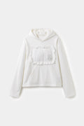 Pillow Hoodie in off-white, with a padded pillow patch sewn onto the chest.
