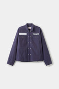 Secret Plumber Jacket in dark violet cotton twill, front view with the blank name patch and the STF Plumbing Services patch at the chest.