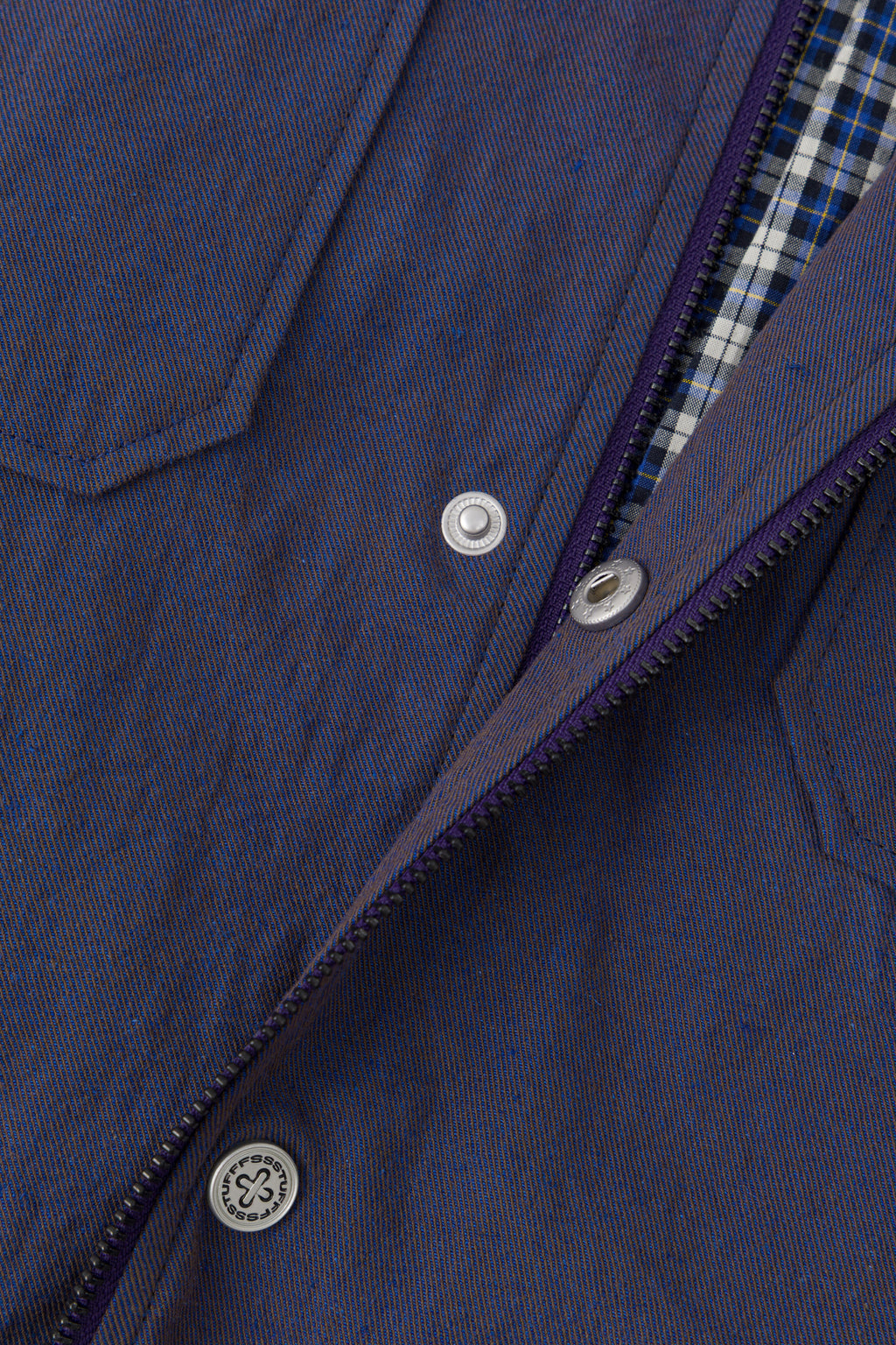 The front zip opened, showing the blue check flannel lining.