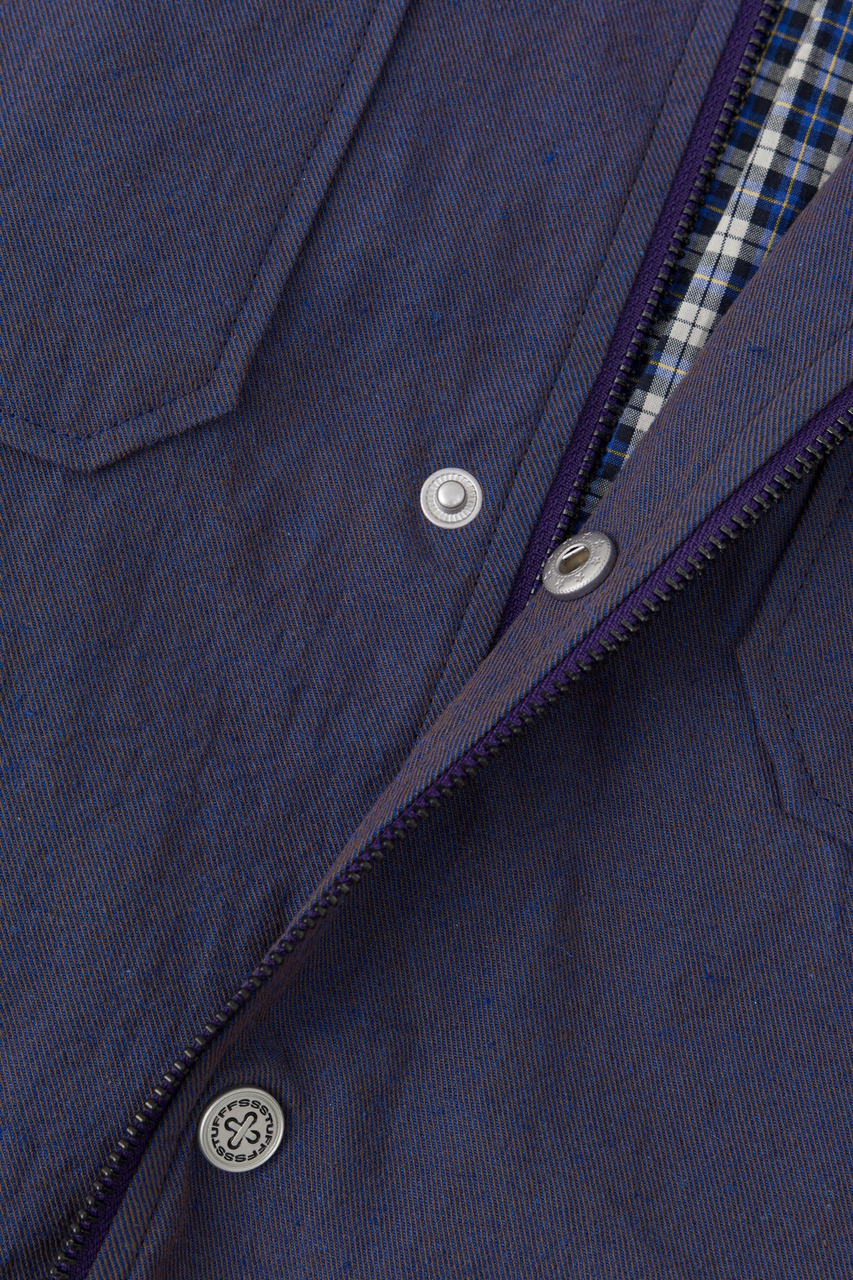 The front zip opened, showing the blue check flannel lining.
