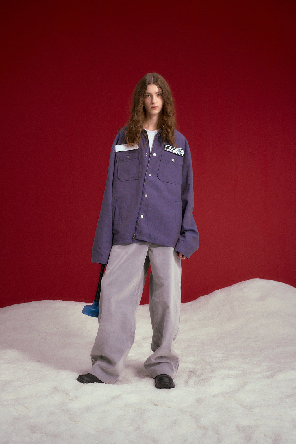 Secret Plumber Jacket in lilac, with velcro chest pockets and a Plumbing Services print at the back. Worn on a model, full-length front view.