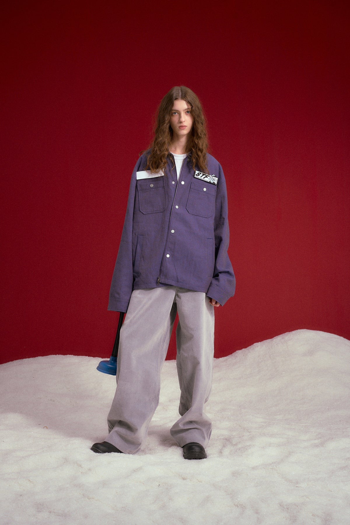 Secret Plumber Jacket in lilac, with velcro chest pockets and a Plumbing Services print at the back. Worn on a model, full-length front view.