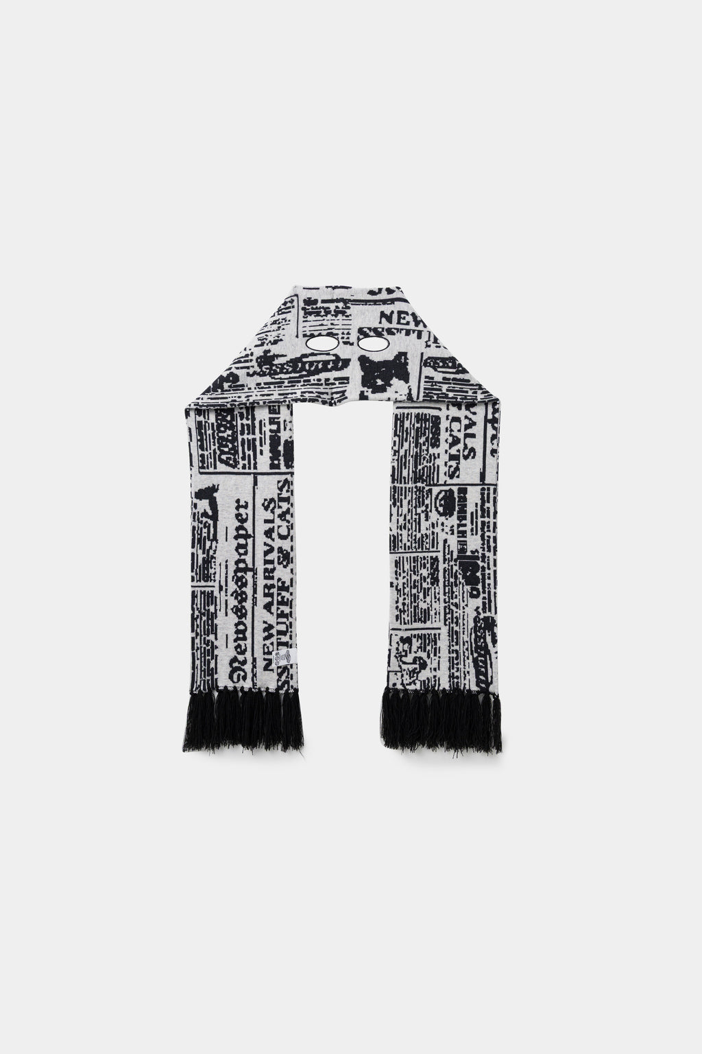 Back view of the newsprint scarf, folded double to show the full length and the fringed ends.