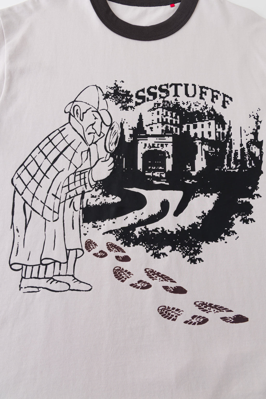 Close-up of the detective and city print with the footprints in their cool dark state.