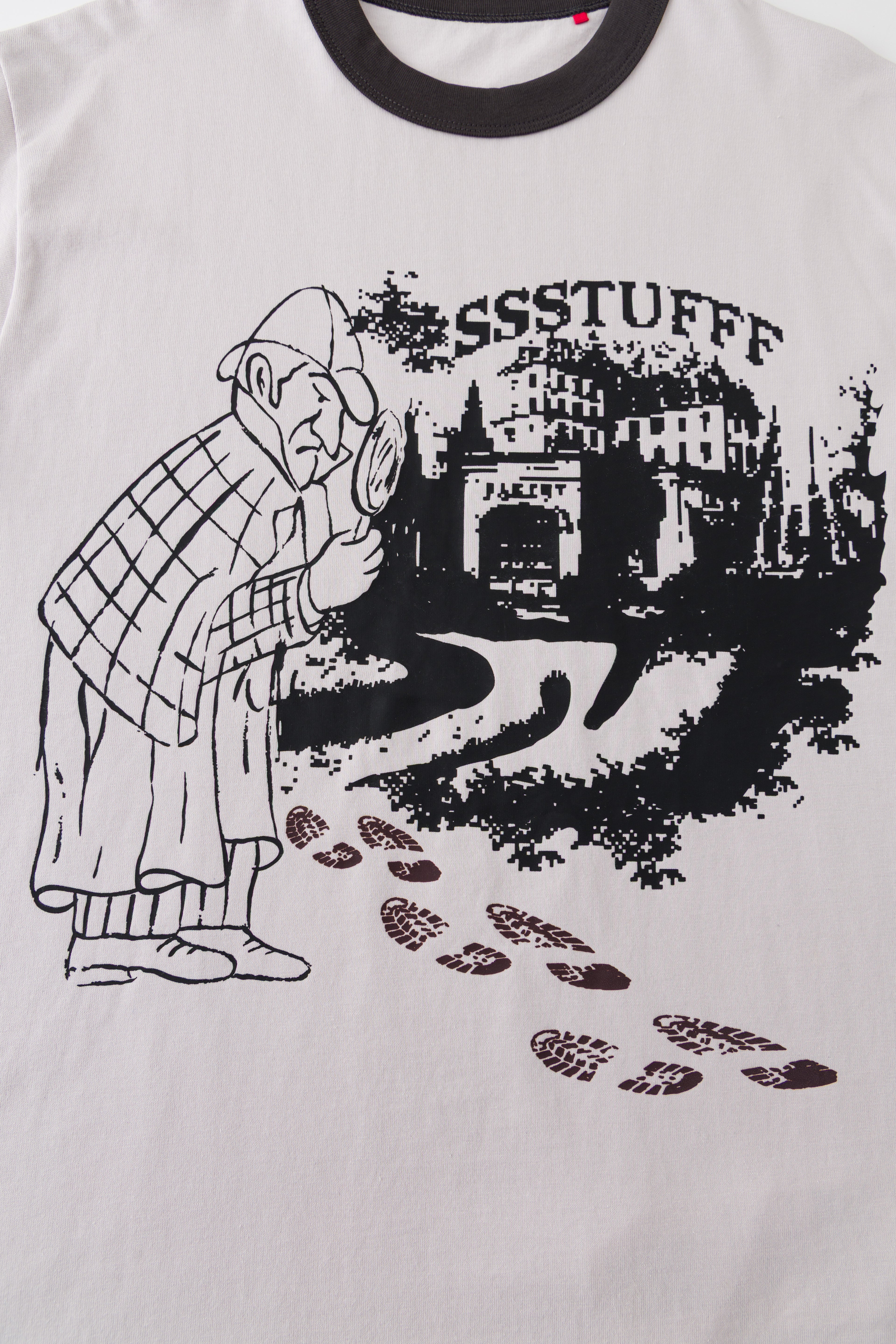 Close-up of the detective and city print with the footprints in their cool dark state.