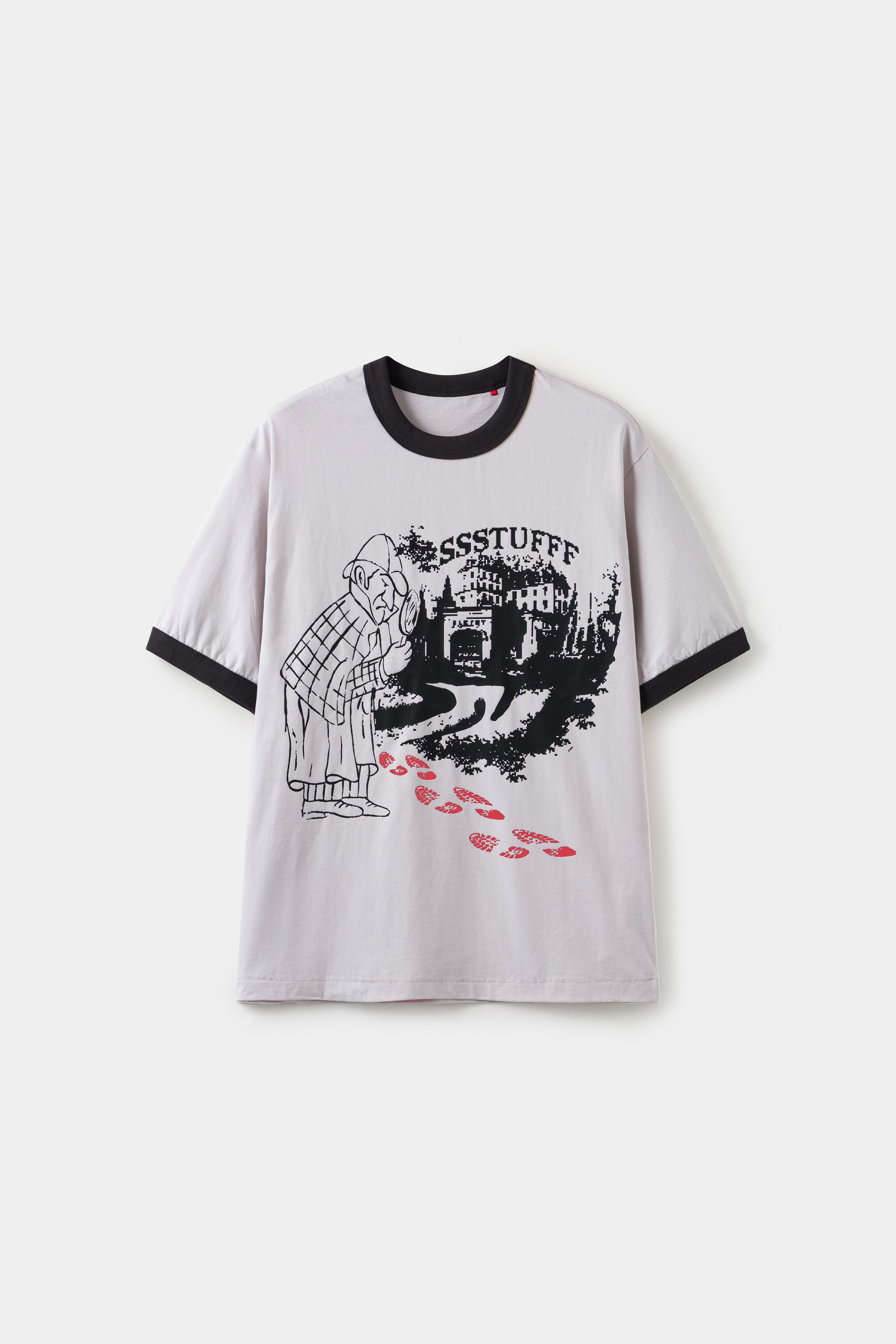 The same tee with the footprints turned red after warming, showing the thermochromic reveal.