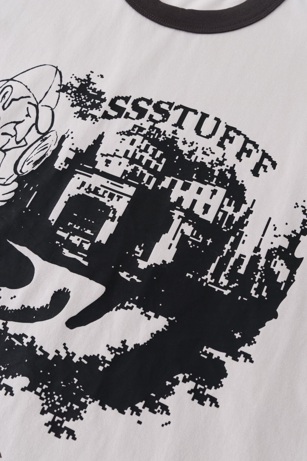 Detail of the arched SSSTUFFF lettering and city skyline in the front print.