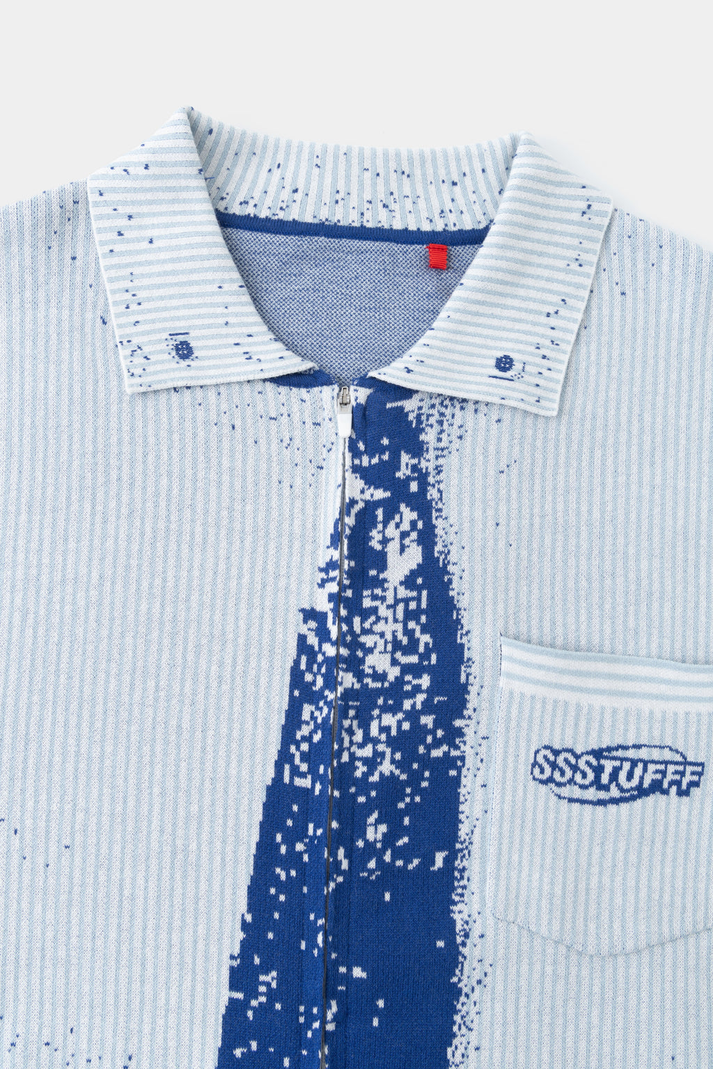 Close-up of the knitted collar, red Ssstufff tab and the blue trompe l'oeil tie.