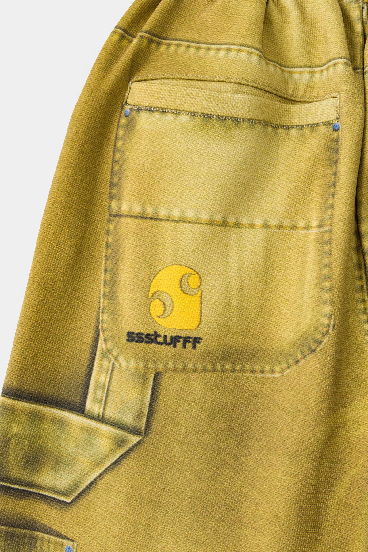 Detail of the printed carpenter pocket with the Ssstufff logo at the side seam.