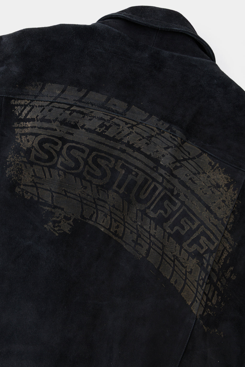 Detail of the tyre track print arcing across the back with SSSTUFFF set into it.