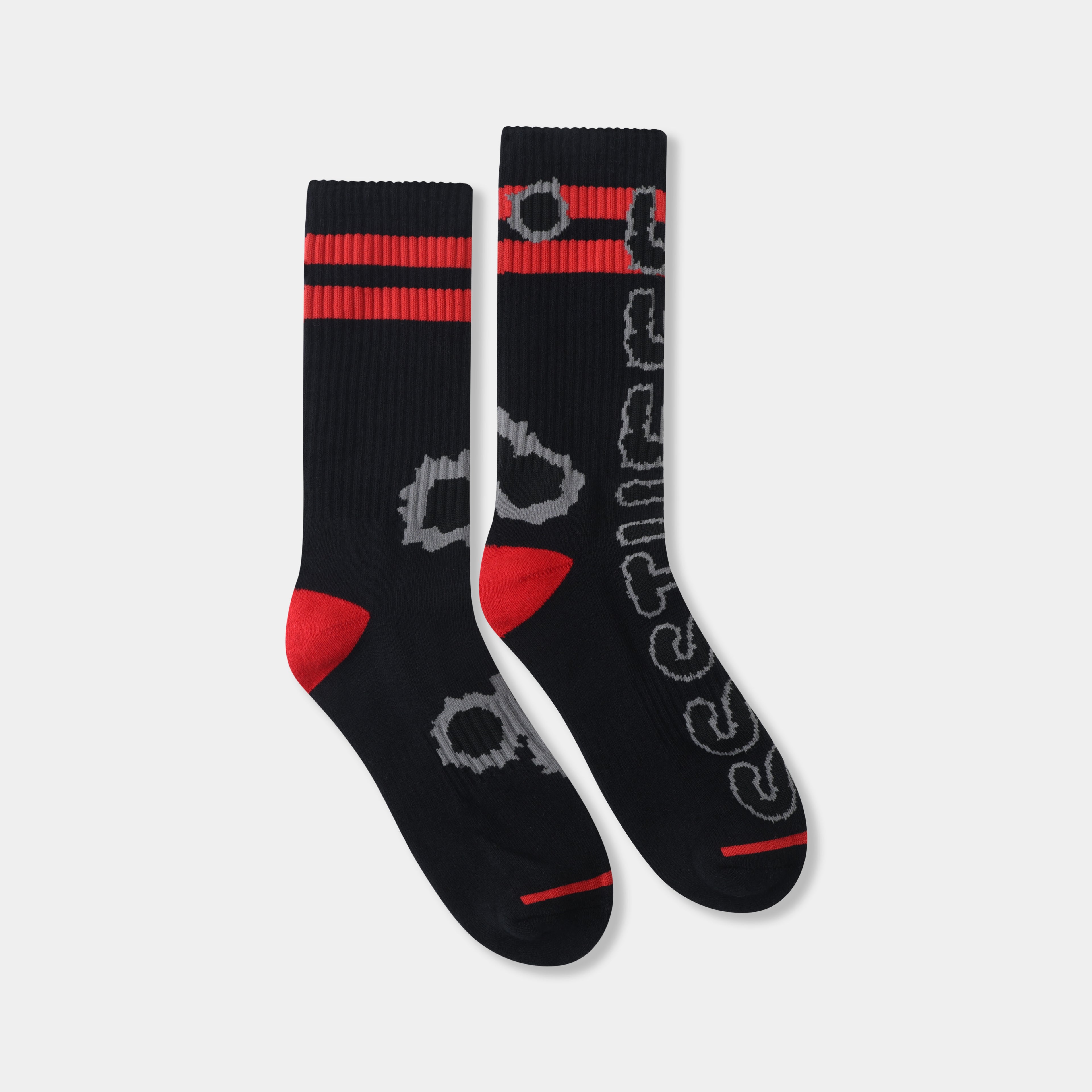 Gunshots Socks in black, ribbed crew socks with red stripes, red heels and toes, and grey bullet-hole jacquard down the leg.