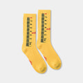 Ruler Socks in yellow, ribbed crew socks knitted end to end as a tape measure with a red Ssstufff logo at the ankle.