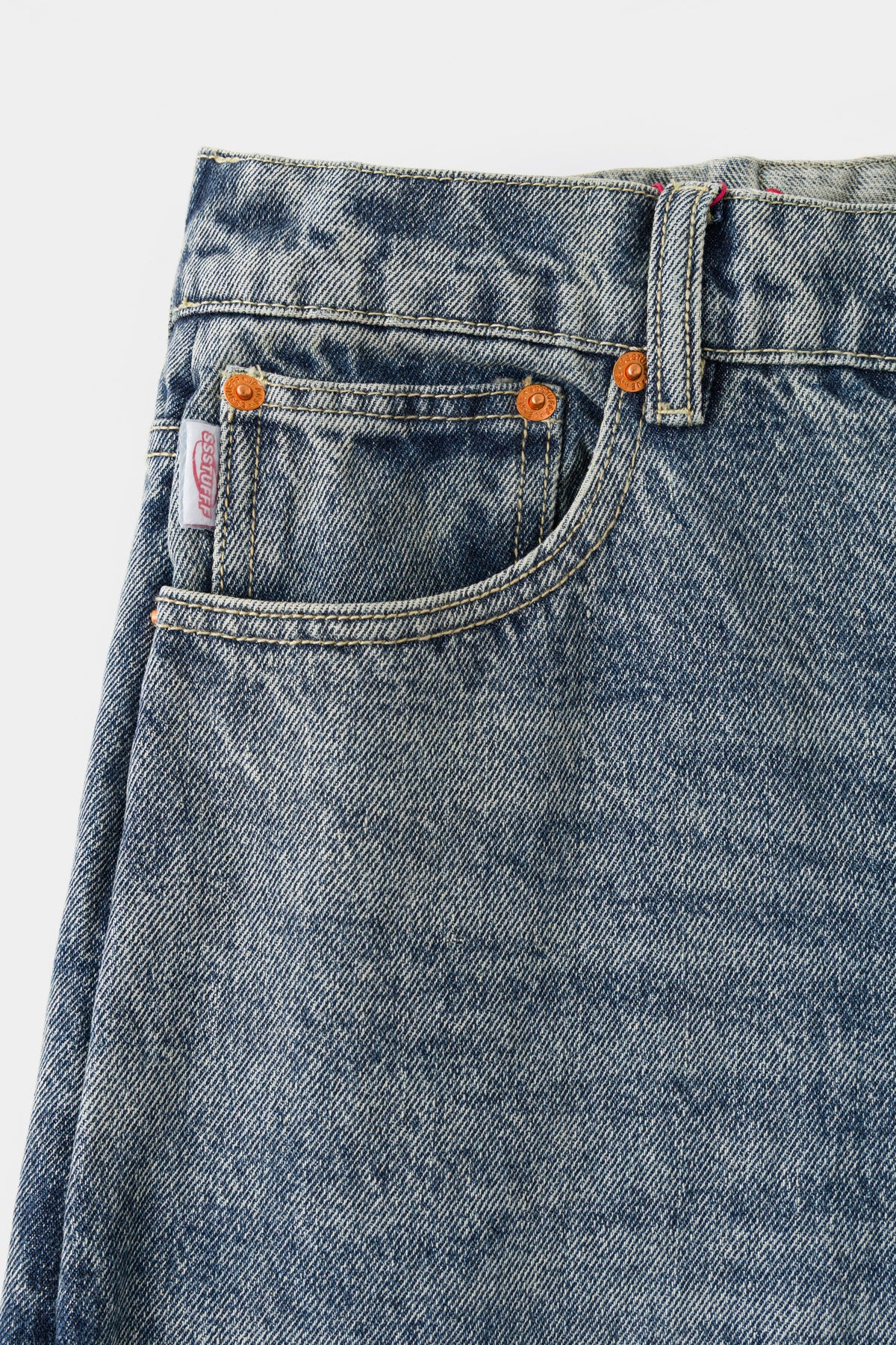 Close-up of the front waistband, coin pocket and orange-tab rivets.