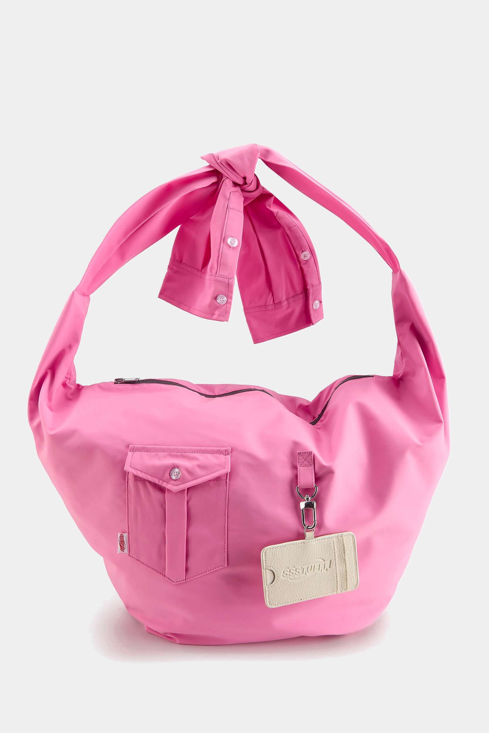 Pink Shirtsleeve Bag with knotted sleeve handles, flap pocket and a hanging leather cardholder