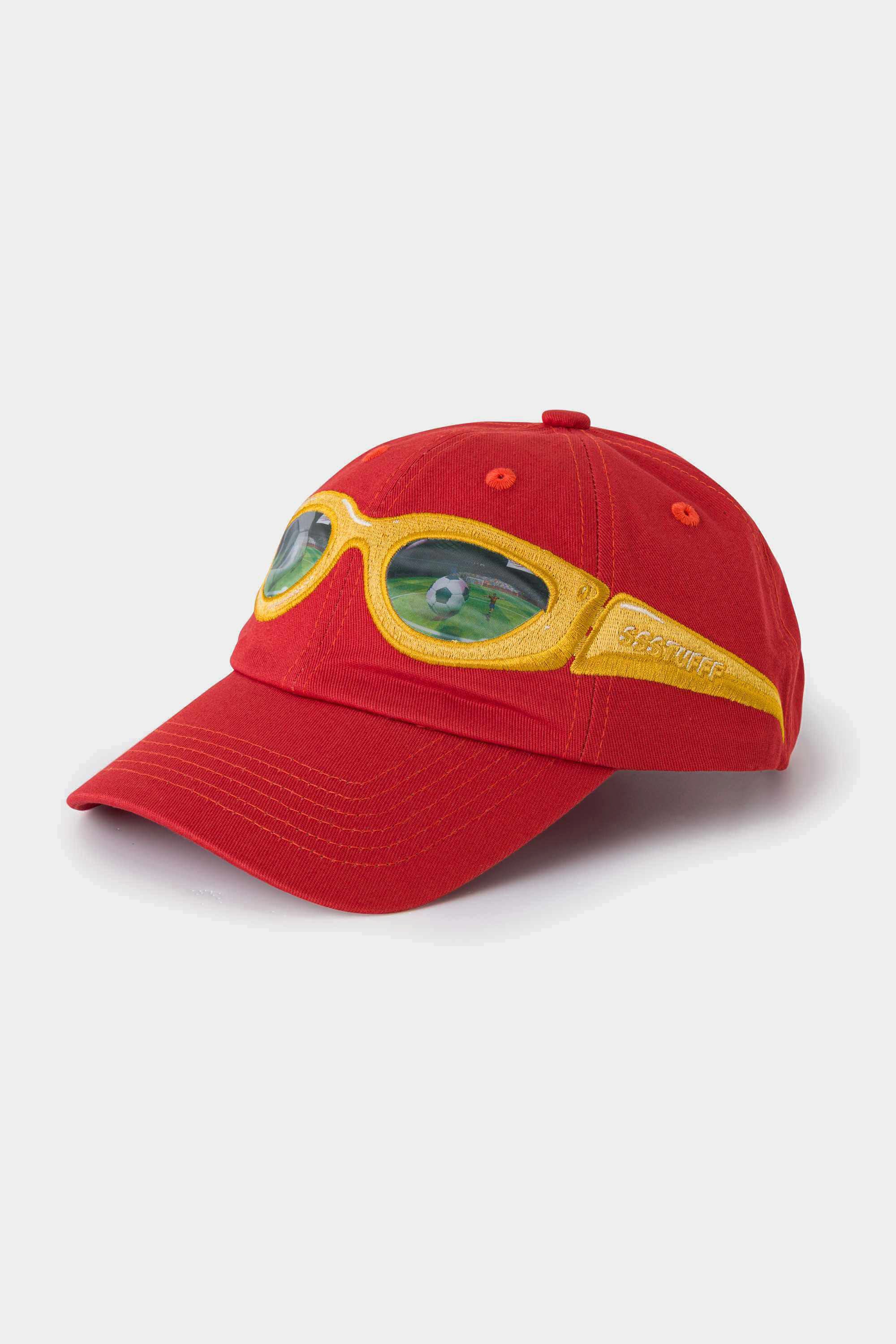 Red cotton cap with a yellow lenticular sunglasses patch stitched across the front panel and brim
