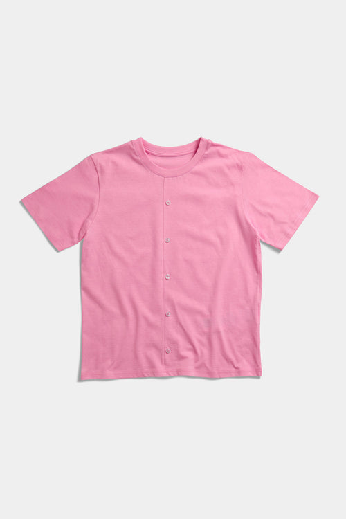 Pink t-shirt laid flat with a functional button placket running down the front