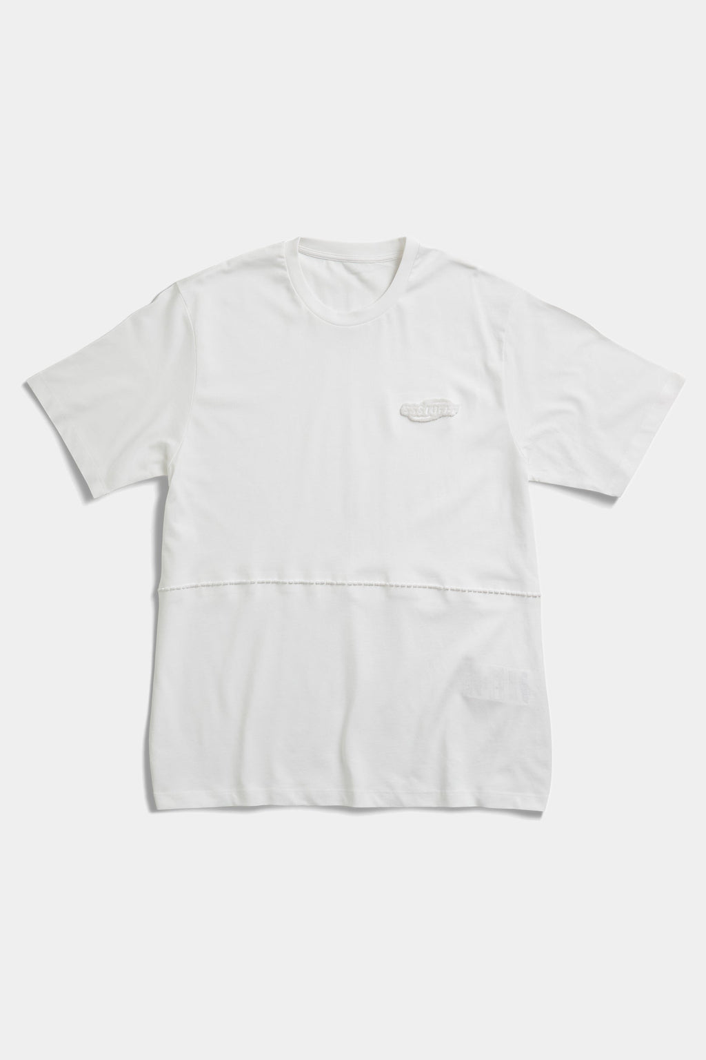 White FUWARI Embroidery Tee laid flat, showing the panelled waist seam and tonal chest embroidery
