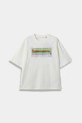 White SSSTUFFF t-shirt with a hand-sewn LOOOOOST DOG poster patch taped to the chest, showing a dachshund and tear-off tabs